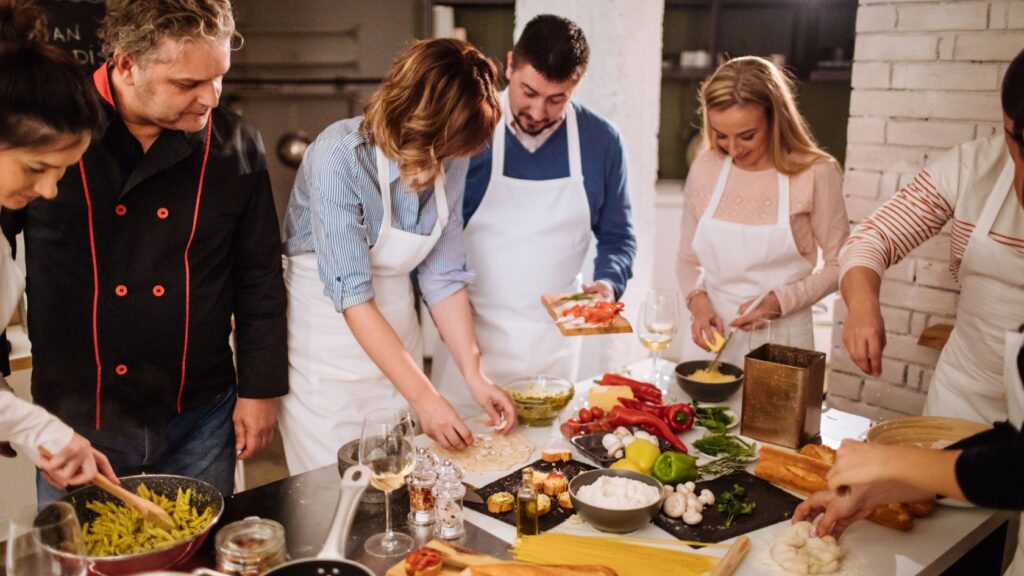 people cooking pasta and vegetables